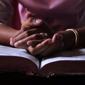 A picture of woman praying over scripture.